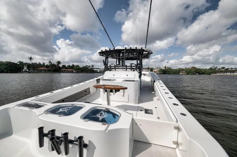 Slide: The Image of 2020 Freeman 42LR boat on calm water under a partly cloudy sky. - 42