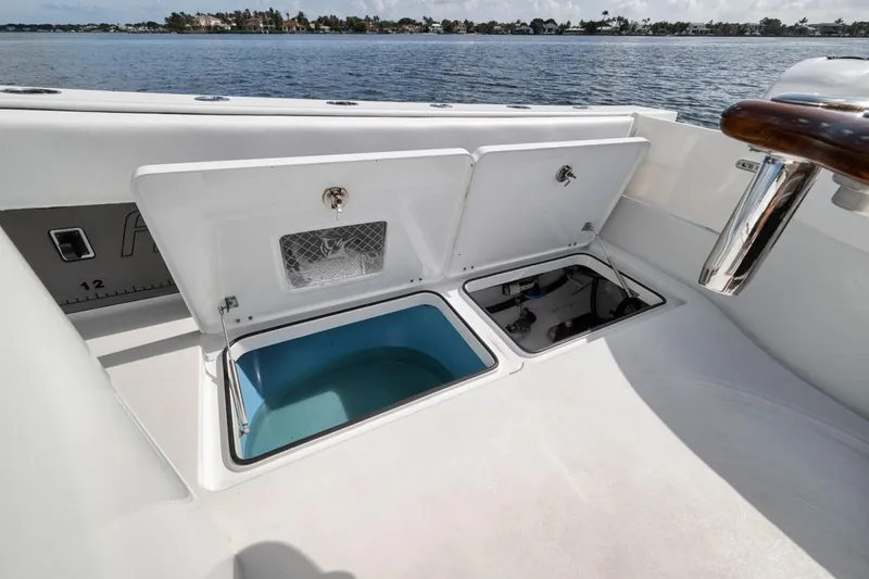 Slide: The Image of Open storage compartments on a 2020 Freeman 42LR boat, with ocean view in background. - 43