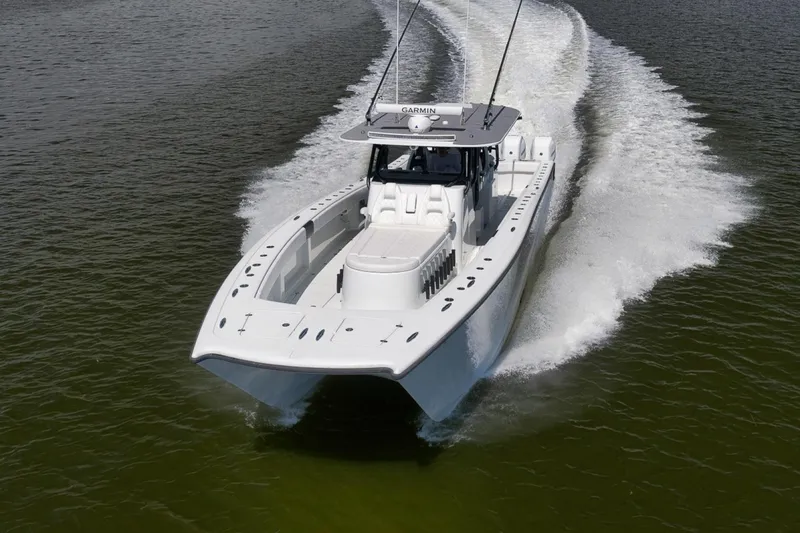 Slide: The Image of 2020 Freeman 42LR boat cruising on water, showcasing sleek design and performance. - 45
