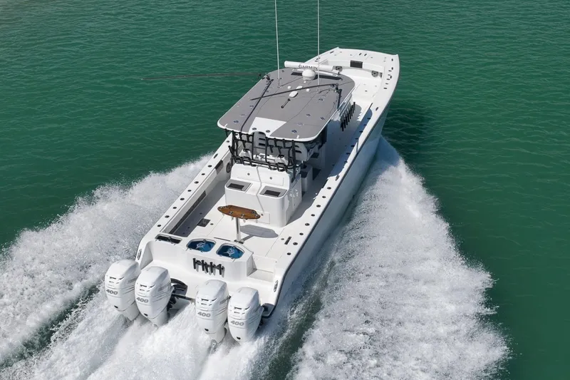 Slide: The Image of Freeman 42LR 2020 boat cruising on clear turquoise water, rear view. - 47