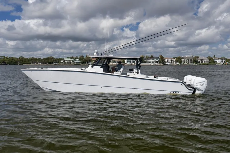 Slide: The Image of 2020 Freeman 42LR boat on water, featuring sleek design and powerful engines. - 8