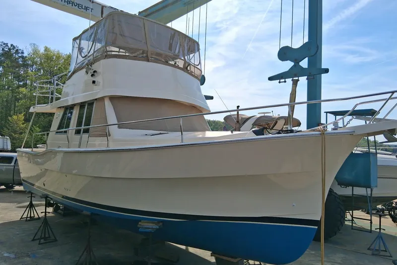 The Image of 2004 Mainship 390 Trawler on dry dock, showcasing its sleek design and sturdy build. - 1