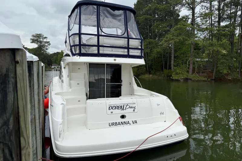 Slide: The Image of 2007 Sea Ray 44 Sedan Bridge docked in Urbanna, VA, surrounded by lush greenery. - 10