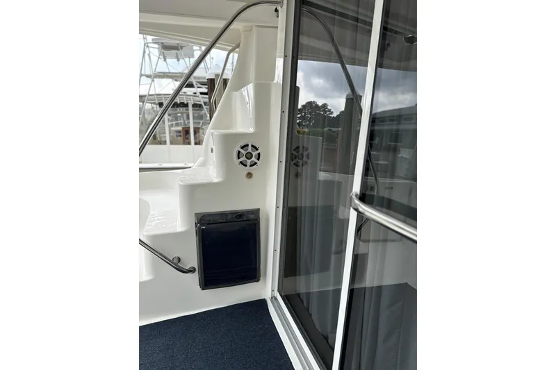 Slide: The Image of 2007 Sea Ray 44 Sedan Bridge yacht interior with stairs and glass door. - 14