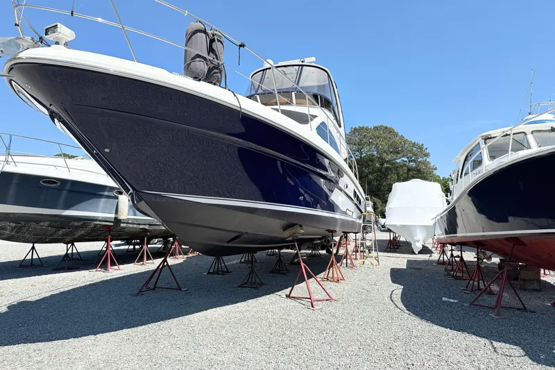 Slide: The Image of 2007 Sea Ray 44 Sedan Bridge yacht on stands in a boatyard. - 2