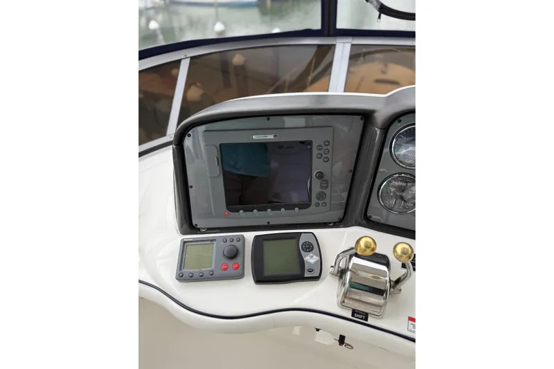 Slide: The Image of 2007 Sea Ray 44 Sedan Bridge helm with navigation controls and gauges. - 20