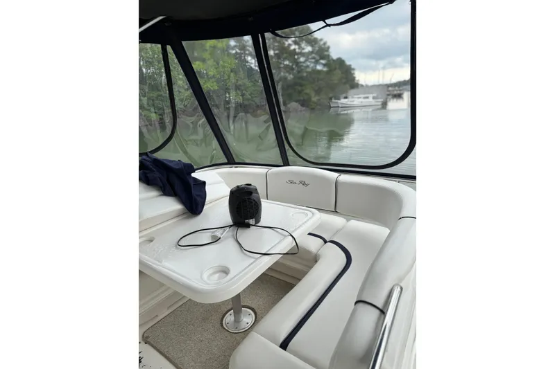 Slide: The Image of Interior of 2007 Sea Ray 44 Sedan Bridge with table, seating, and scenic water view. - 22