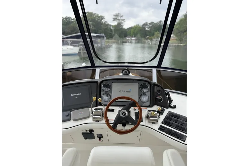 Slide: The Image of 2007 Sea Ray 44 Sedan Bridge helm with Garmin and Raymarine navigation systems. - 23