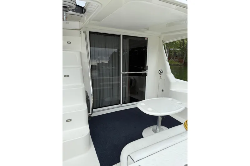 Slide: The Image of 2007 Sea Ray 44 Sedan Bridge yacht interior with sliding glass door and seating area. - 25