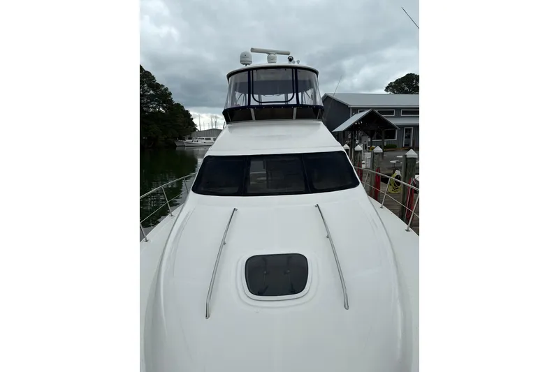 Slide: The Image of 2007 Sea Ray 44 Sedan Bridge yacht docked, showcasing sleek design and spacious deck. - 27