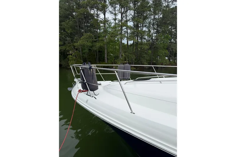 Slide: The Image of 2007 Sea Ray 44 Sedan Bridge yacht docked near lush green trees. - 28