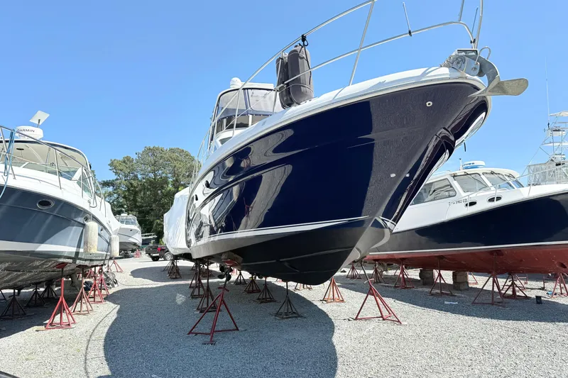 Slide: The Image of 2007 Sea Ray 44 Sedan Bridge yacht on stands, surrounded by other boats, under clear blue sky. - 3