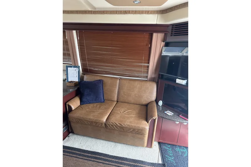 Slide: The Image of Interior of 2007 Sea Ray 44 Sedan Bridge with leather sofa and TV. - 35