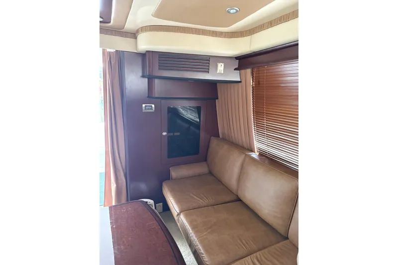 Slide: The Image of Interior of 2007 Sea Ray 44 Sedan Bridge with leather seating and wooden blinds. - 36