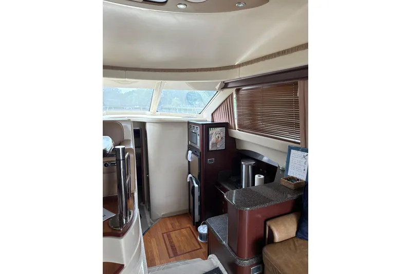 Slide: The Image of Interior of 2007 Sea Ray 44 Sedan Bridge yacht with modern amenities and wood accents. - 40
