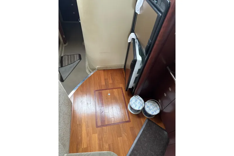 Slide: The Image of Interior of 2007 Sea Ray 44 Sedan Bridge with wooden flooring and storage compartments. - 41