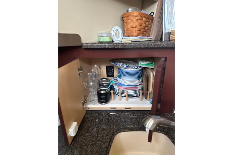 Slide: The Image of Kitchen cabinet in 2007 Sea Ray 44 Sedan Bridge, storing dishes and glassware. - 45