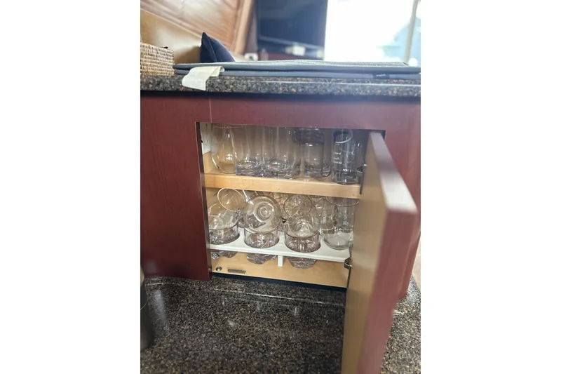Slide: The Image of Cabinet with glassware inside a 2007 Sea Ray 44 Sedan Bridge yacht. - 46