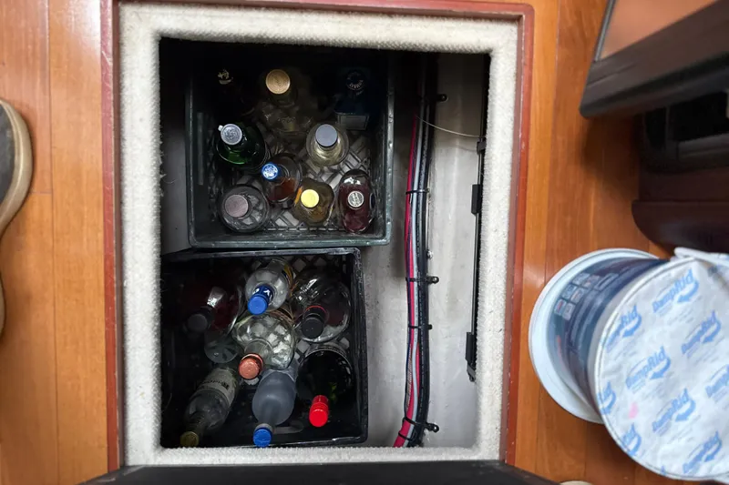 Slide: The Image of Hidden storage compartment with bottles on a 2007 Sea Ray 44 Sedan Bridge yacht. - 47