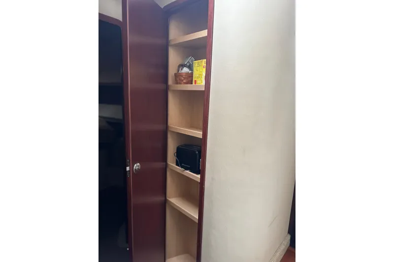 Slide: The Image of Open wooden cabinet with shelves inside a 2007 Sea Ray 44 Sedan Bridge yacht. - 49
