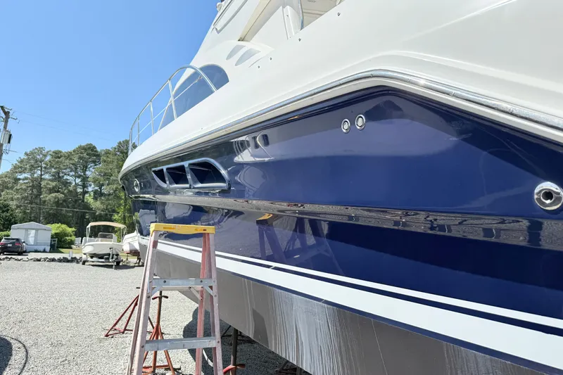 Slide: The Image of 2007 Sea Ray 44 Sedan Bridge yacht with blue hull, parked outdoors. - 5