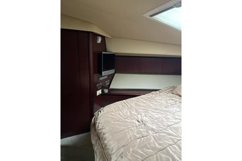 Slide: The Image of Luxurious cabin interior of 2007 Sea Ray 44 Sedan Bridge yacht with TV and bedding. - 52