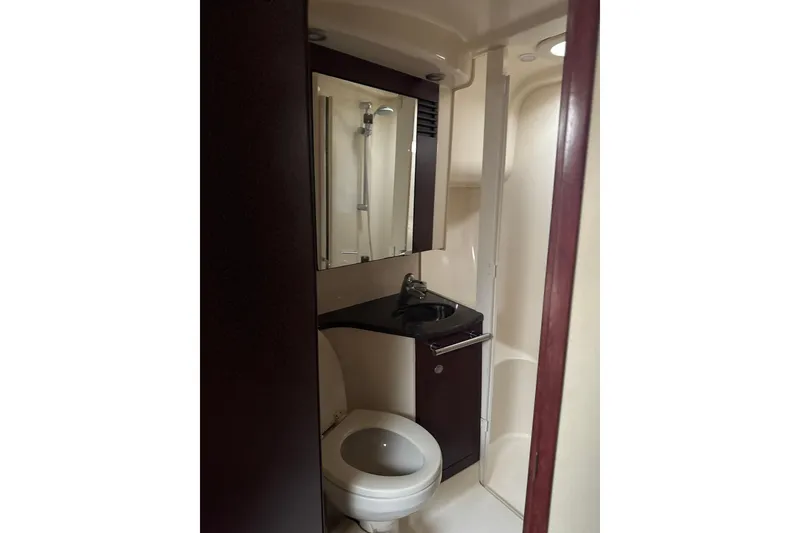 Slide: The Image of Bathroom interior of 2007 Sea Ray 44 Sedan Bridge yacht, featuring sink and toilet. - 53