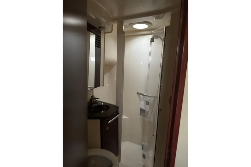 Slide: The Image of Bathroom interior of 2007 Sea Ray 44 Sedan Bridge yacht, featuring shower and sink. - 55
