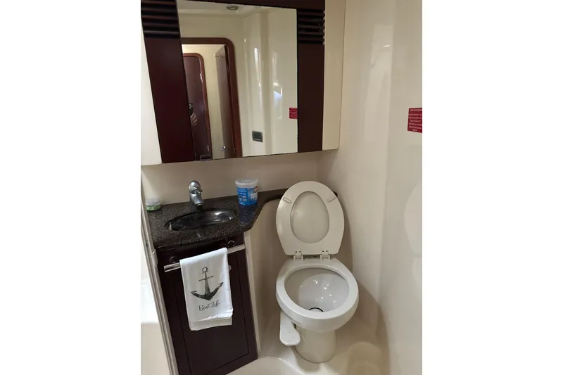 Slide: The Image of Bathroom interior of 2007 Sea Ray 44 Sedan Bridge yacht, featuring sink and toilet. - 56