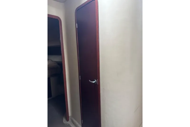Slide: The Image of Interior view of 2007 Sea Ray 44 Sedan Bridge, featuring a wooden door. - 58
