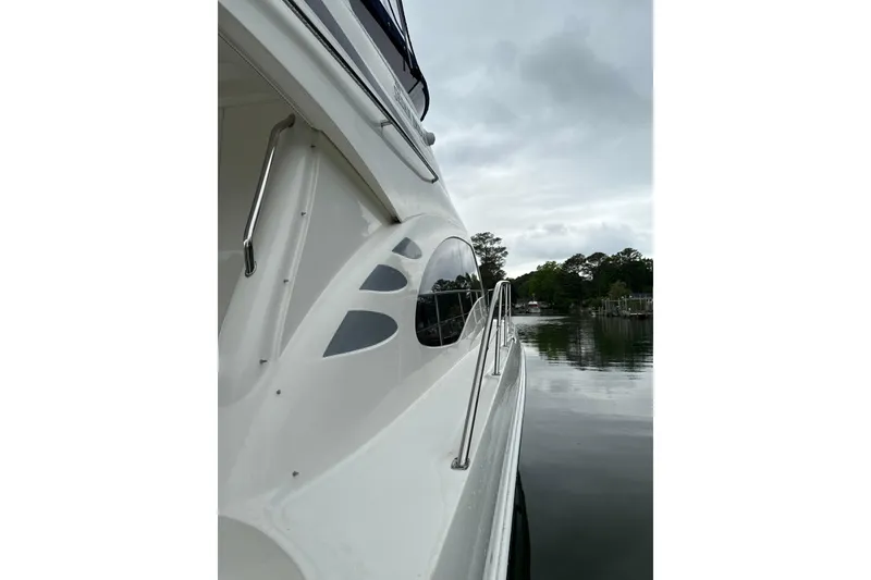 Slide: The Image of Side view of a 2007 Sea Ray 44 Sedan Bridge yacht on calm water. - 59