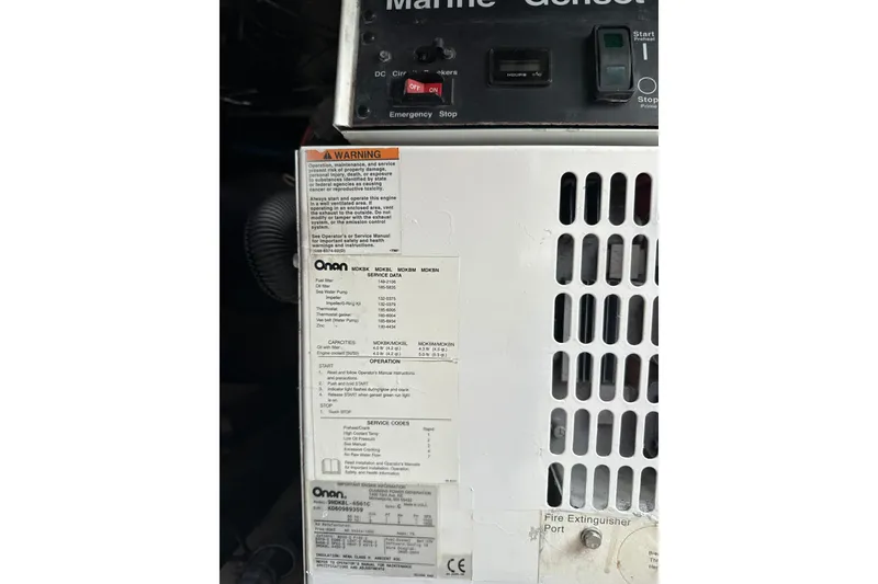 Slide: The Image of Onan generator panel with warning label on 2007 Sea Ray 44 Sedan Bridge. - 62