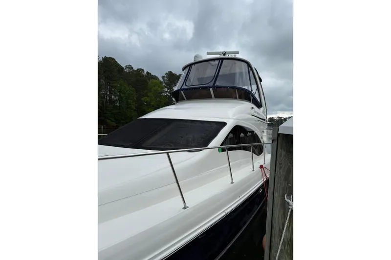 Slide: The Image of 2007 Sea Ray 44 Sedan Bridge yacht docked under cloudy skies. - 7