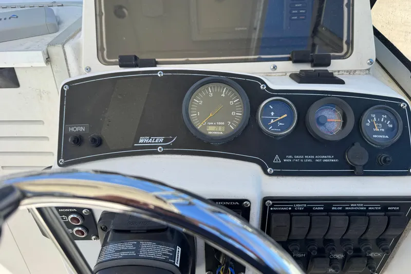 Slide: The Image of Dashboard of a 2000 Boston Whaler 21 Conquest boat with Honda gauges and controls. - 6