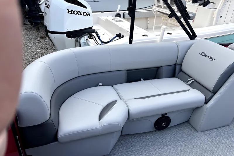 Slide: The Image of 2026 Bentley Pontoons Legacy 220 Navigator with luxurious seating and Honda outboard motor. - 12
