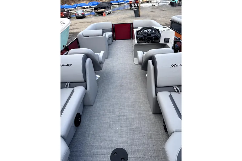 Slide: The Image of 2026 Bentley Pontoons Legacy 220 Navigator interior with gray seating and modern dashboard. - 8