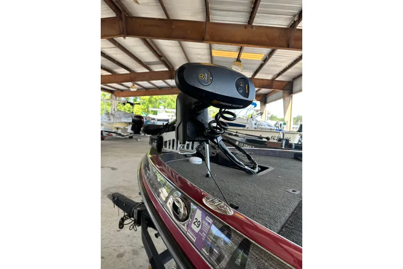 Slide: The Image of 2017 Ranger Z518 Comanche boat with Minn Kota trolling motor in a covered storage area. - 3