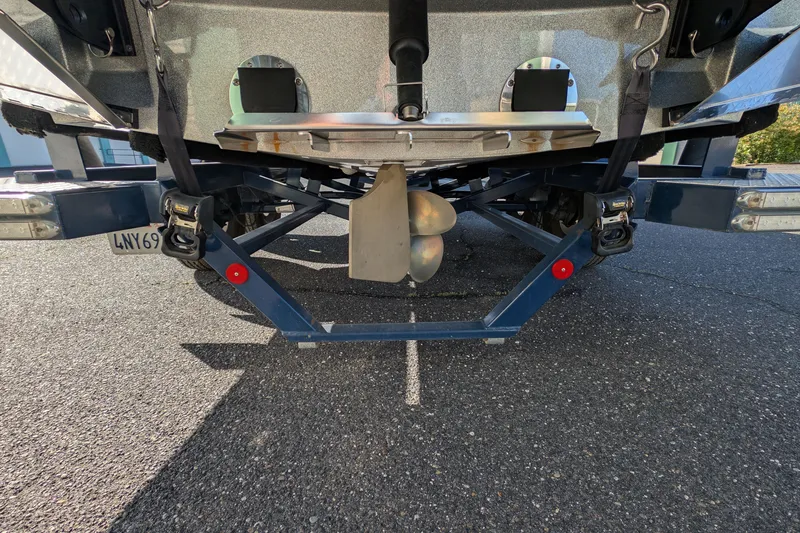 Slide: The Image of Rear view of 2016 MasterCraft X10 boat on trailer, showing propeller and hull details. - 13