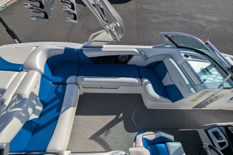 Slide: The Image of 2016 MasterCraft X10 boat interior with blue and white seating, sleek design. - 21