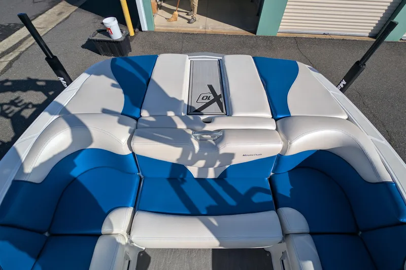 Slide: The Image of 2016 MasterCraft X10 boat interior with blue and white seating. - 25