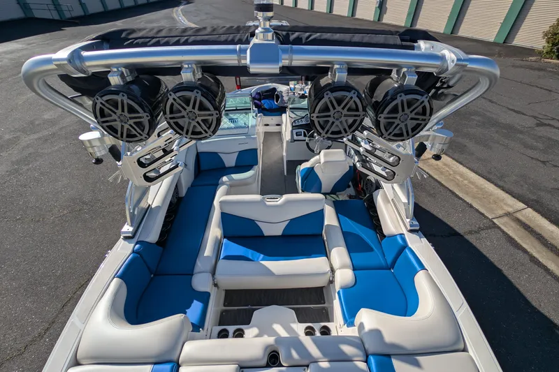 Slide: The Image of 2016 MasterCraft X10 boat interior with blue and white seating, speakers, and sleek design. - 27