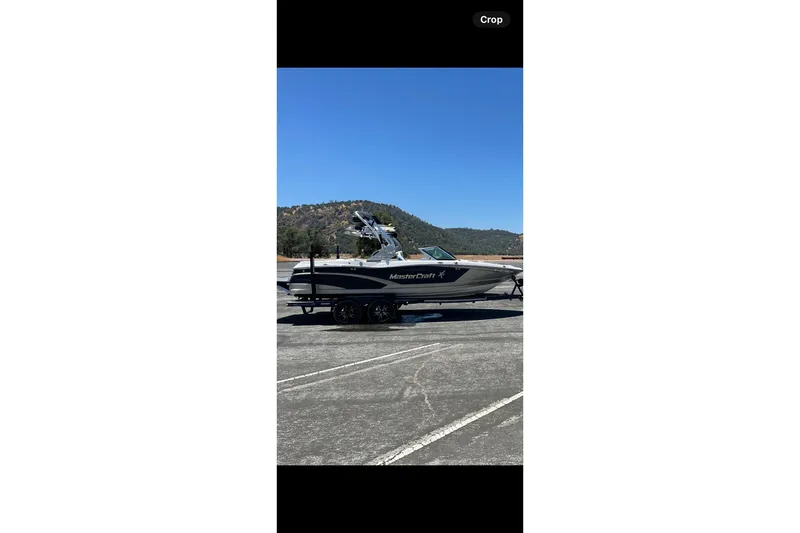 Slide: The Image of 2016 MasterCraft X10 boat on trailer, parked outside storage facility. - 3