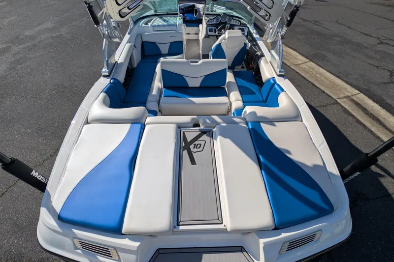 Slide: The Image of 2016 MasterCraft X10 boat interior with blue and white seating, showcasing luxury design. - 30