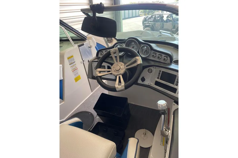 Slide: The Image of 2016 MasterCraft X10 boat dashboard with steering wheel and control panel. - 39