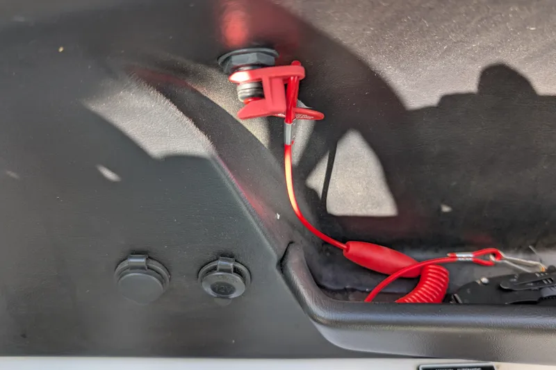 Slide: The Image of Red safety lanyard in a 2016 MasterCraft X10 boat interior. - 44