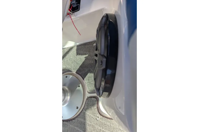 Slide: The Image of 2016 MasterCraft X10 boat interior detail with speaker and carpeted floor. - 47