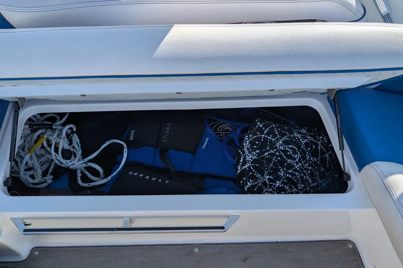 Slide: The Image of Storage compartment in a 2016 MasterCraft X10 boat with ropes and gear. - 48