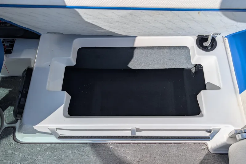 Slide: The Image of Open storage compartment in a 2016 MasterCraft X10 boat interior. - 49