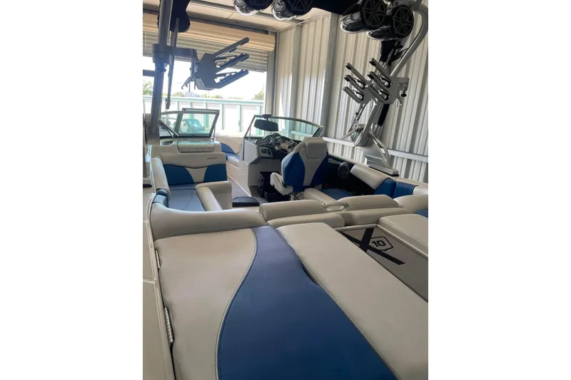 Slide: The Image of 2016 MasterCraft X10 boat on trailer, parked outdoors under a clear sky. - 5