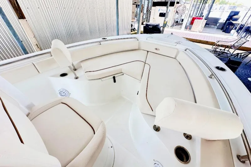 Slide: The Image of 2020 Sea Hunt Ultra 234 boat interior with white cushioned seating. - 3